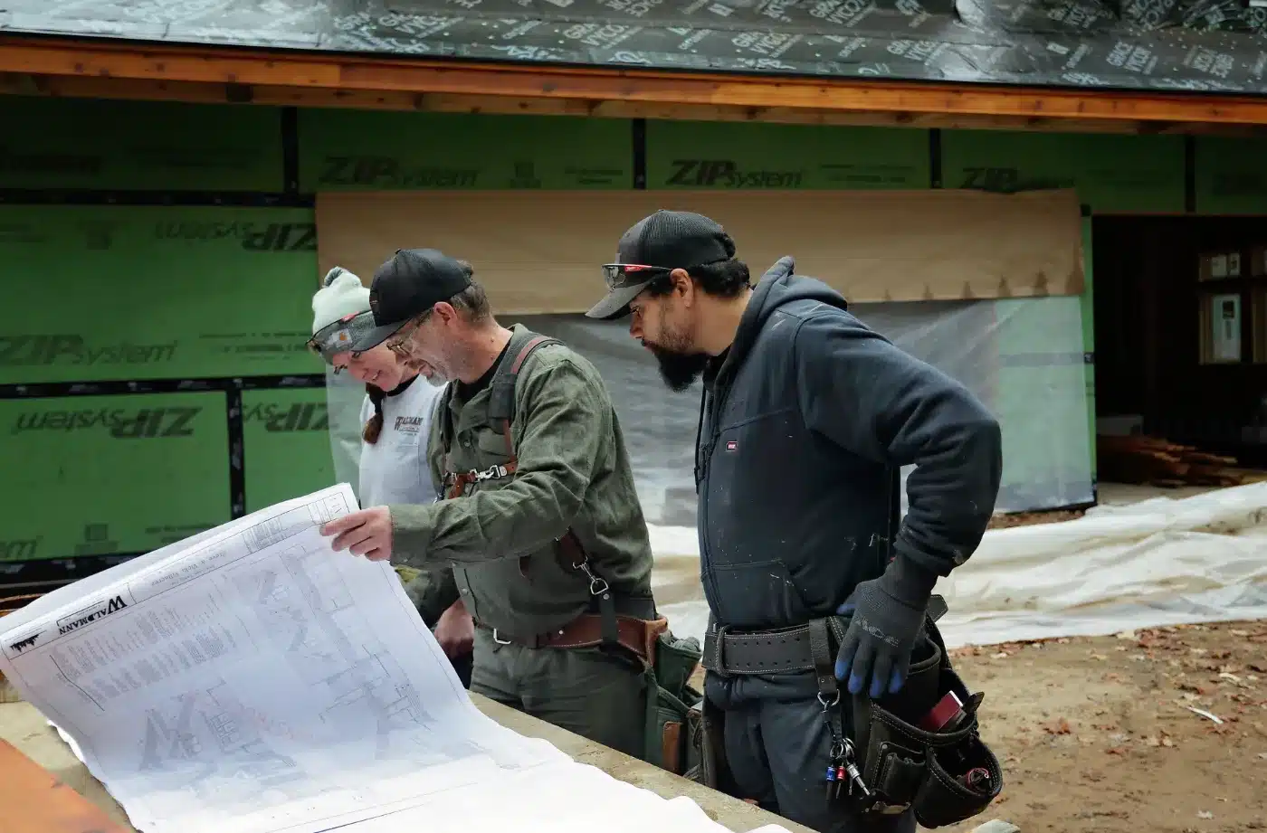 Waldmann Construction team discussing energy efficient blueprints on site