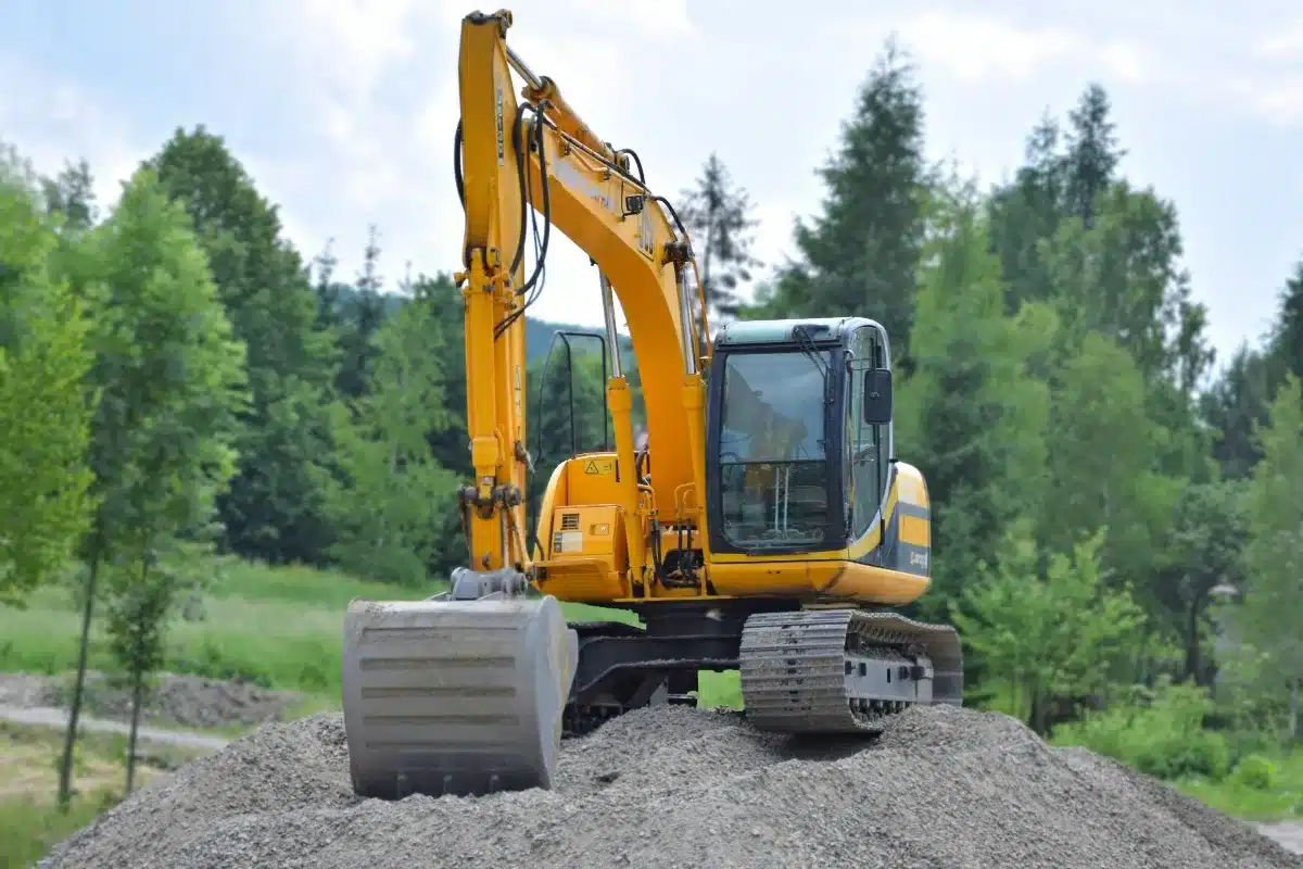 Excavator carefully clearing a designated area on a Northwoods property